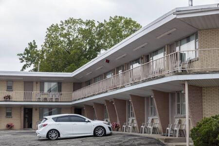 A white car at the typical north american motel buildingの写真素材