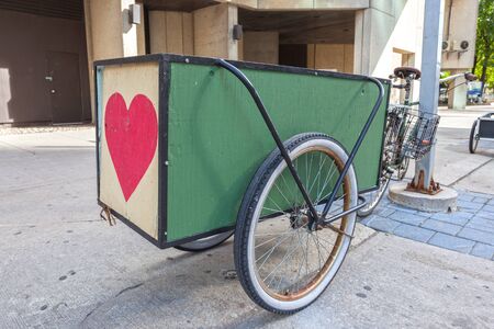 Bike with a trailer parked downtown in the city 