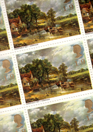 Detail from a sheet of vintage United Kingdom postage stamps featuring a painting of The Haywain by John Constable.の写真素材