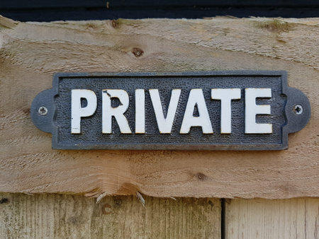 Private sign on a wooden wall in the shape of a rectangle.の写真素材