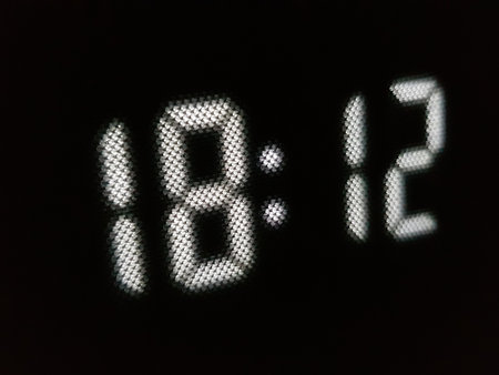 LED display with white numbers 18:12 on a black backgroundの写真素材