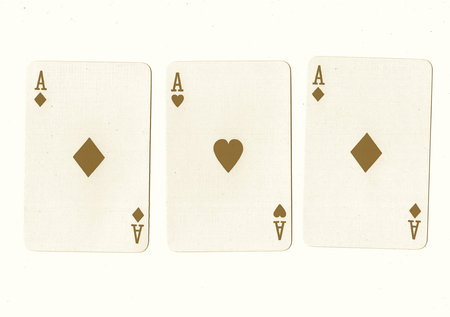 Playing cards on a white background. Vintage style toned picture.の写真素材