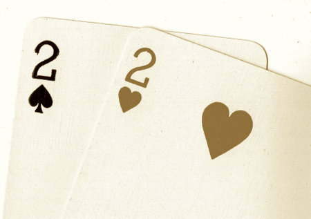 playing cards with two aces on a white background, closeup of photoの写真素材