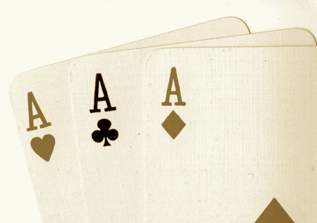 Playing cards with a royal flush on a white background in sepia