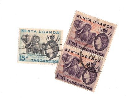 Vintage postage stamps from Kenya, Uganda and Tanganyika isolated on a white background.