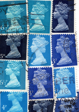 Vintage Queen Elizabeth II postage stamps from Great Britain isolated on a white background.の写真素材