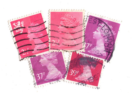 Vintage Queen Elizabeth II postage stamps from Great Britain isolated on a white background.の写真素材