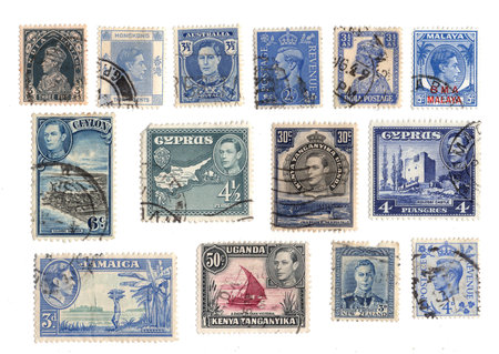 Collection of vintage King George VI postage stamps from different countries of the world isolated on a white background.の写真素材