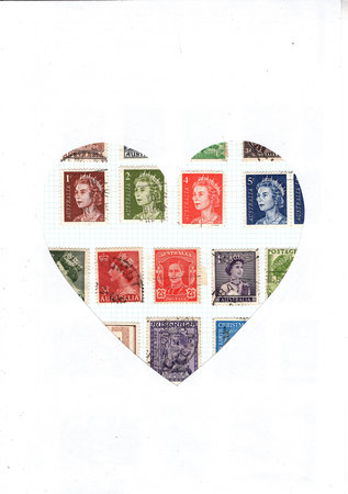 Vintage postage stamps from Australia on a stamp album page in the shape of a heart.の写真素材