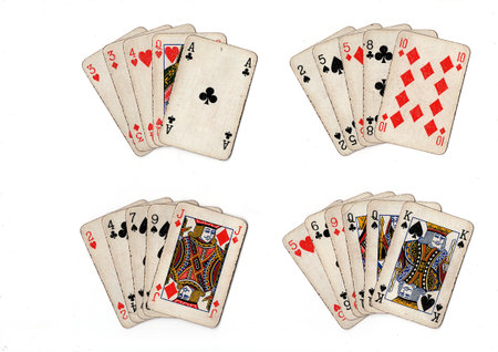 poker hands of old grubby playing cards in different combinations on a white background.