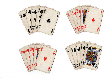 poker hands of old grubby playing cards in different combinations on a white background.の写真素材