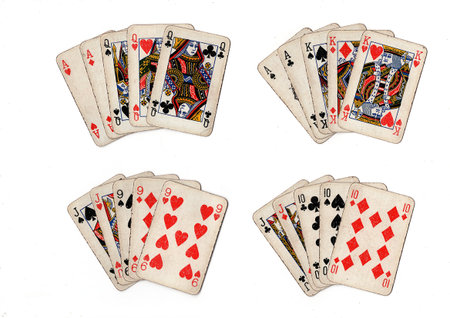 poker hands of old grubby playing cards in different combinations on a white background.の写真素材