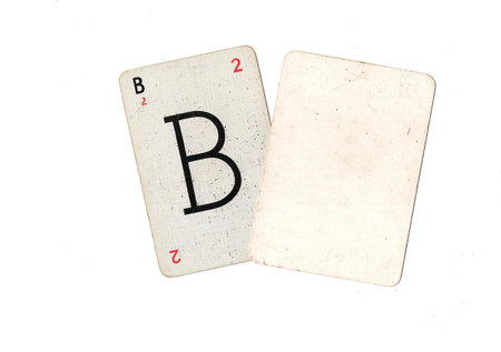 A vintage alphabet playing card with one blank card for text or copy on a white background.の写真素材