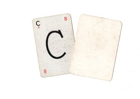 A vintage alphabet playing card with one blank card for text or copy on a white background.の写真素材