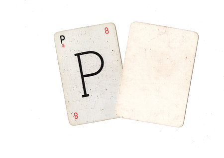 A vintage alphabet playing card with one blank card for text or copy on a white background.の写真素材
