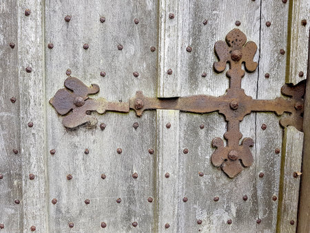 Old wooden door with rusty lock and rivets. Vintage background.