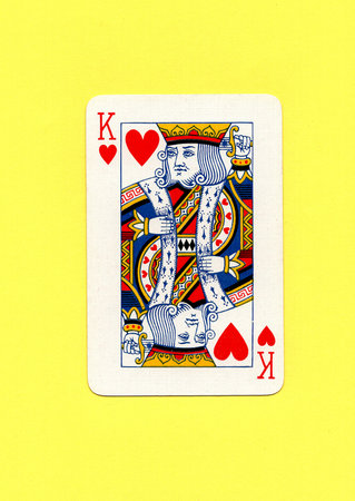 King of hearts playing card on a yellow background.