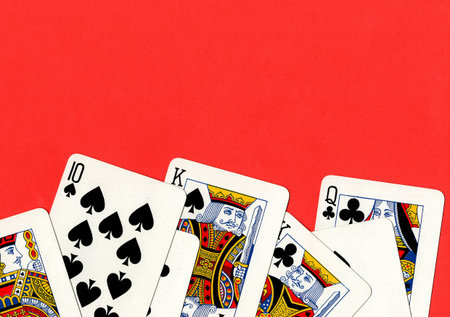Vintage playing cards on a bright red background. Top view, copy space.