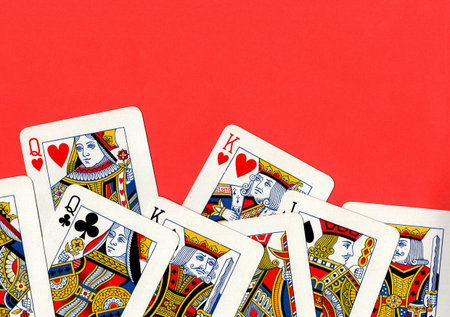 Vintage playing cards on a bright red background. Top view, copy space.の写真素材