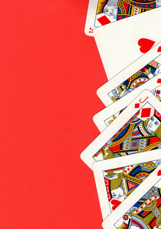 Playing cards on a red background. Top view. Copy space.の写真素材