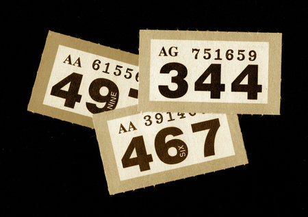 Vintage raffle tickets in sepia on a black background.