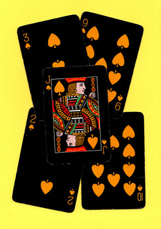 Black vintage playing cards on a bright yellow background.