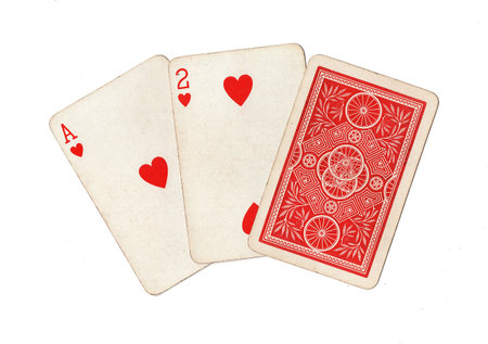 A hand of three vintage playing cards isolated on a white background.