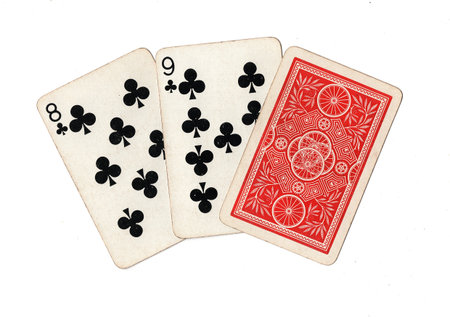 A hand of three vintage playing cards isolated on a white background.