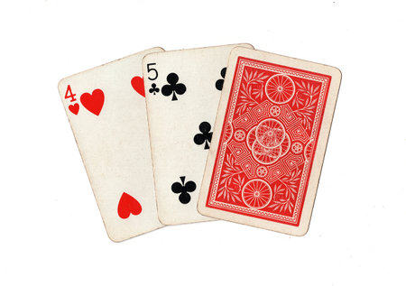 A hand of three vintage playing cards isolated on a white background.
