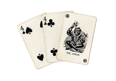 A hand of three vintage playing cards isolated on a white background.