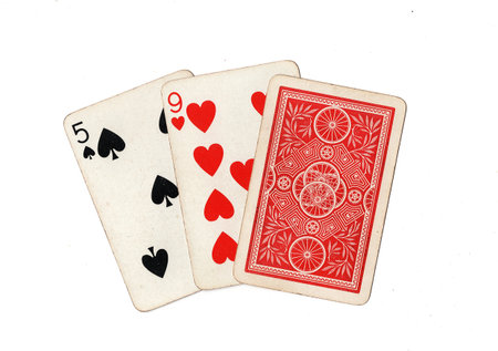 A hand of three vintage playing cards isolated on a white background.