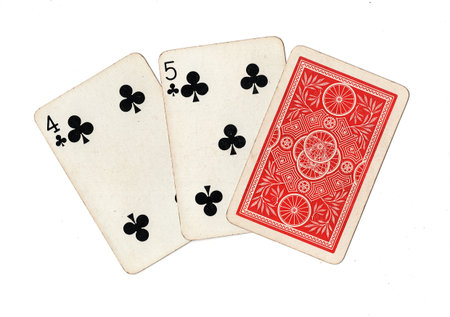 A hand of three vintage playing cards isolated on a white background.
