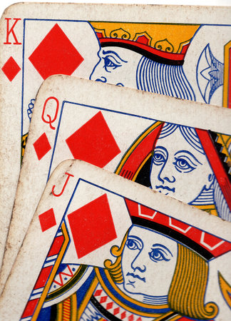 Close up detail showing a run of three vintage playing cards in the same suit.の写真素材