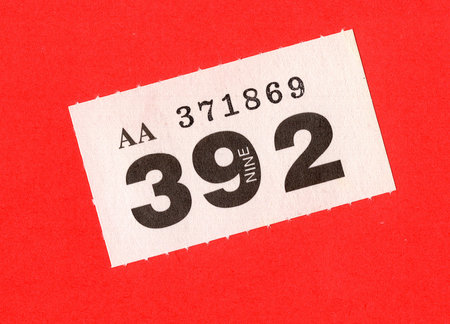 A single raffle ticket on a brightly coloured background.の写真素材