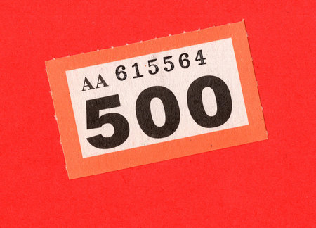 A single raffle ticket on a brightly coloured background.の写真素材