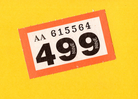 A single raffle ticket on a brightly coloured background.の写真素材