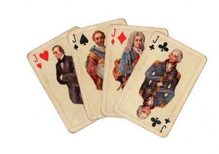 A hand of four vintage picture playing cards isolated on a white background.