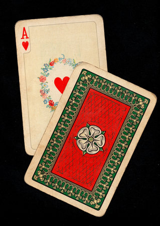 A pair of vintage playing cards isolated on a black background.