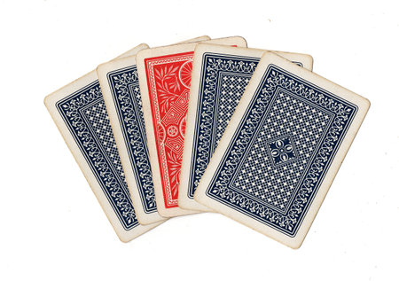A hand of blue vintage playing cards with one red card.