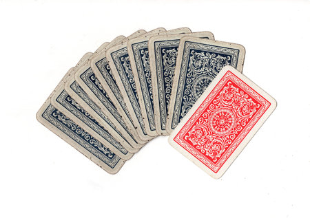 A hand of blue vintage playing cards with one red card.