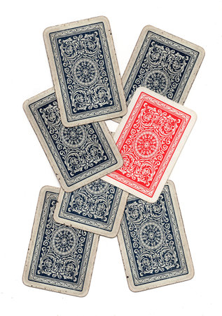 A hand of blue vintage playing cards with one red card.