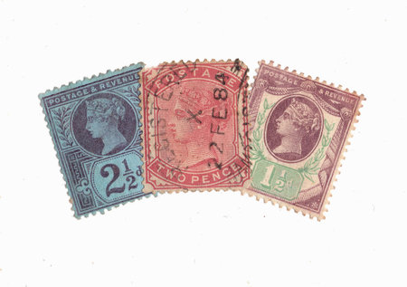 Vintage Queen Victoria postage stamps from Great Britain isolated on a white background.の写真素材