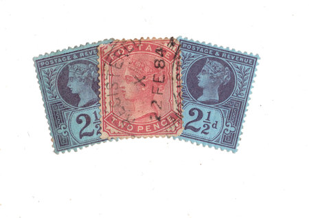 Vintage Queen Victoria postage stamps from Great Britain isolated on a white background.