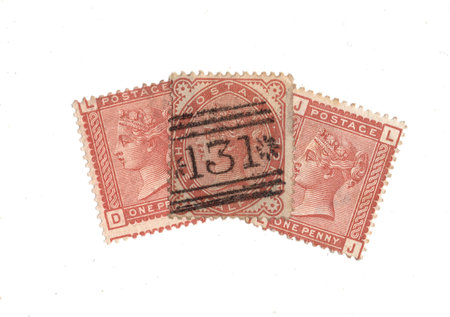 Vintage Queen Victoria postage stamps from Great Britain isolated on a white background.