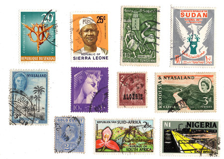 A collection of vintage postage stamps from Africa isolated on a white background.の写真素材