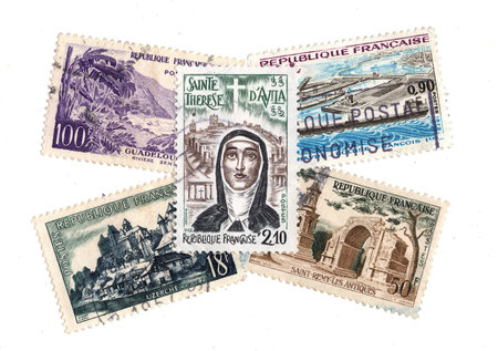 A collection of vintage postage stamps from France isolated on a white background.