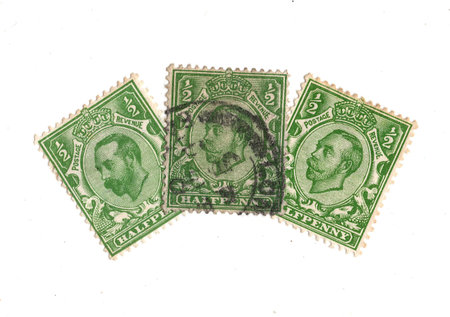 Vintage King George V postage stamps from Great Britain isolated on a white background.の写真素材
