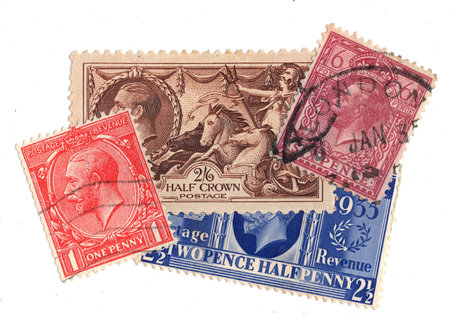 Vintage King George V postage stamps from Great Britain isolated on a white background.