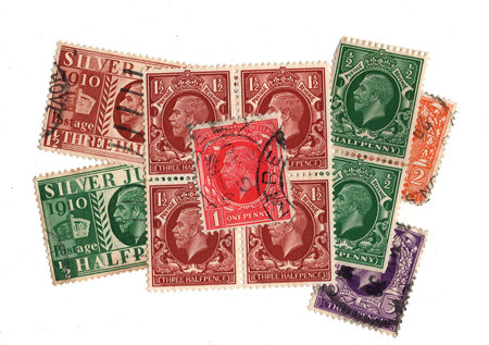 Vintage King George V postage stamps from Great Britain isolated on a white background.