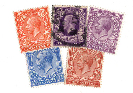 Vintage King George V postage stamps from Great Britain isolated on a white background.